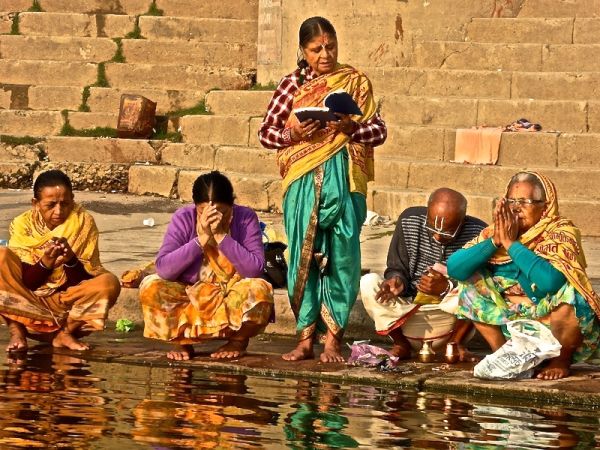 Hindu pilgrims praying by the holy river Hindu pilgrims praying by the holy river