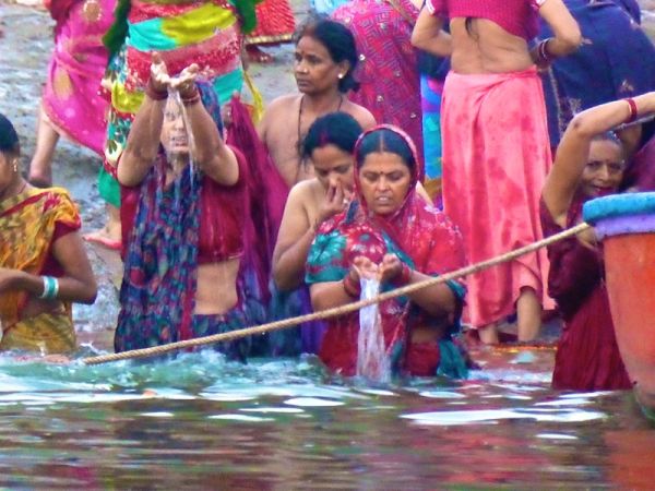 Hindu pilgrims bathing and praying in the holy river Hindu pilgrims bathing and praying in the holy river