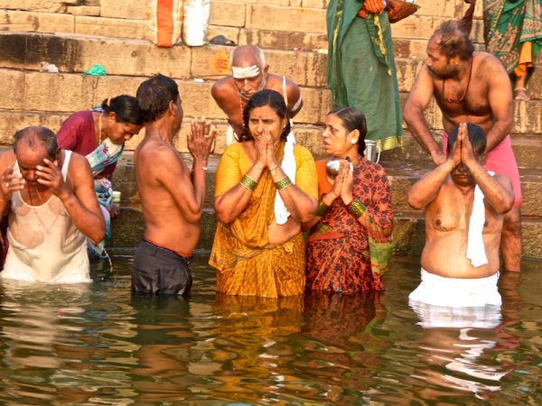 Hindu pilgrims praying and bathing by the ghats Hindu pilgrims praying and bathing by the ghats