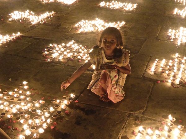 Little girl lighting candles at the Chowki Ghat Little girl lighting candles at the Chowki Ghat