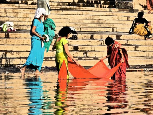 Women doing their laundry in the holy river Women doing their laundry in the holy river