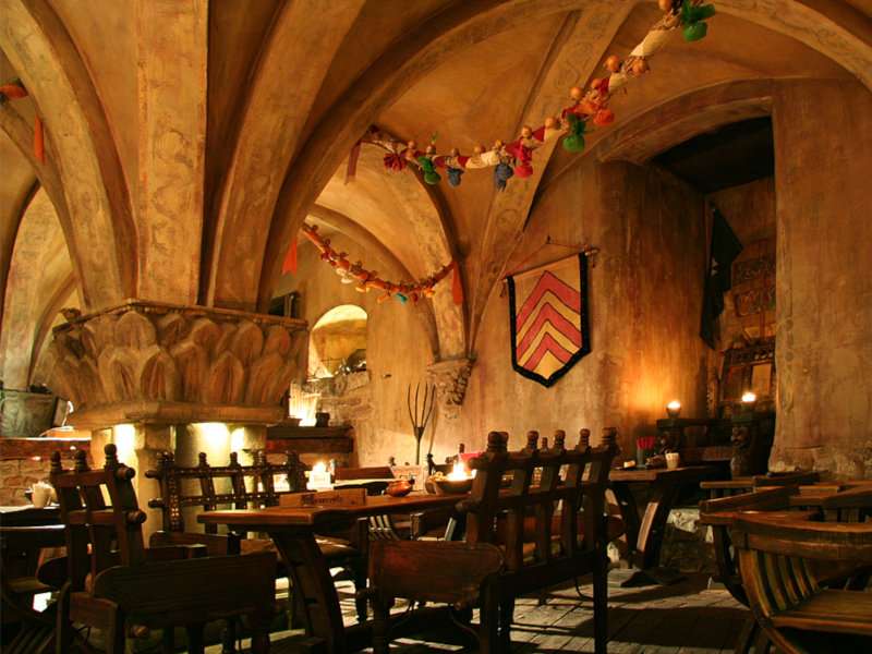 The moody interior of Rozengrals, a medieval themed restaurant in Riga.