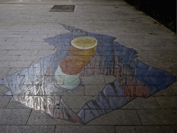 Cigarette stub in Ulan Bator's 3D pavement graffiti