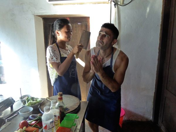 Stefan trying (and failing) to charm our teacher, Mona, at the Yangshuo Cooking School Yangshuo Cooking School class