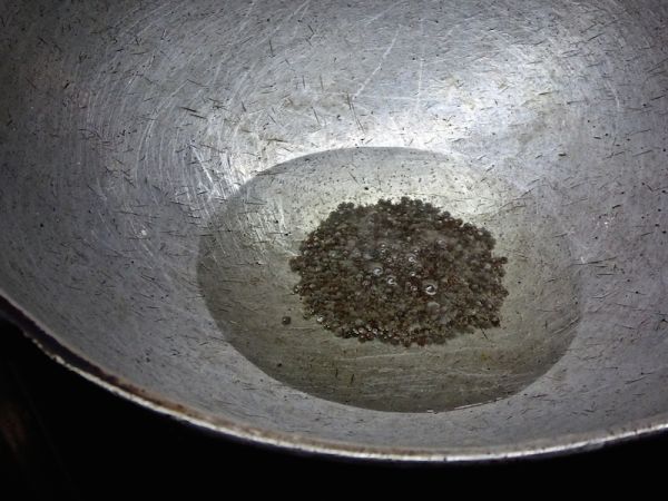 Mustard seeds cooking in coconut oil Mustard seeds cooking in coconut oil