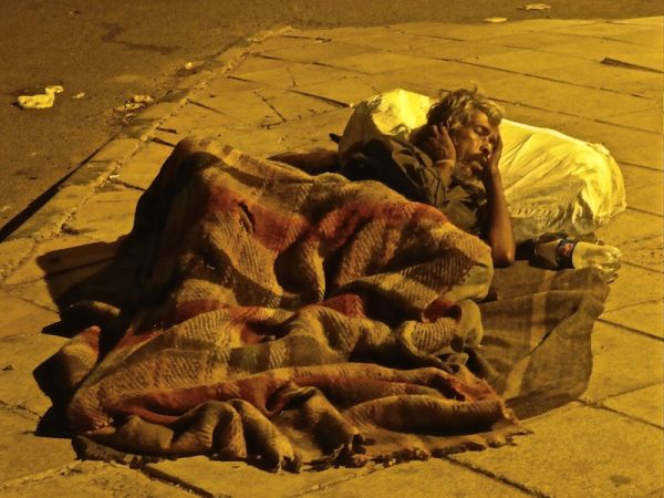 Man sleeping rough on Delhi's streets Love hate India: many people sleeping rough on Delhi main streets