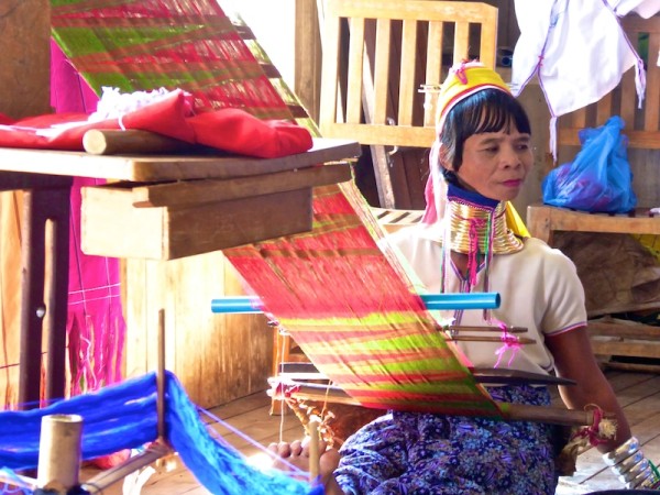 Long necked woman of the Kayan tribe weaving at Inle Lake Long necked woman of the Kayan tribe weaving at Inle Lake