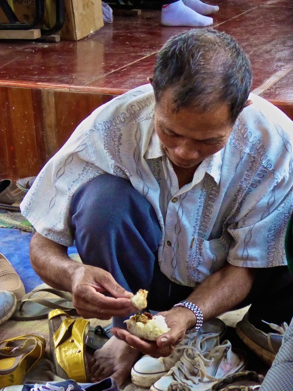 Man eating sticky rice with fingers Man eating sticky rice with fingers