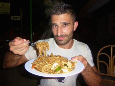 Stefan trying pancit noodles