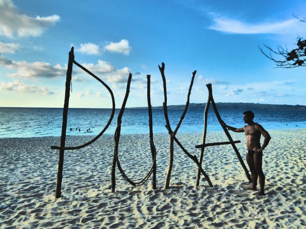 Stefan posing by the Puka beach sign Stefan posing by the Puka beach sign