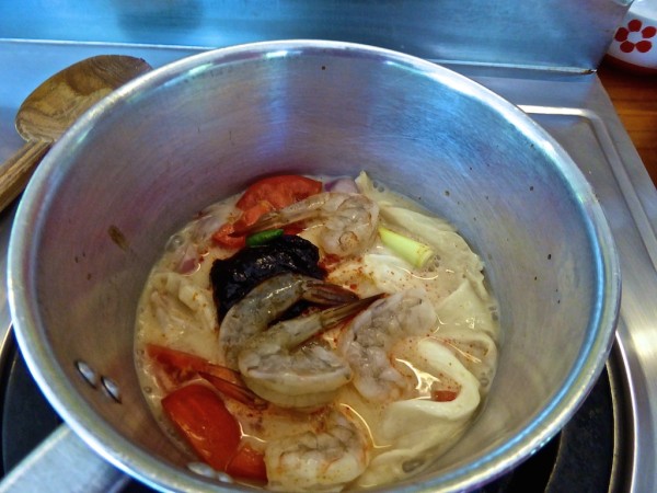 Tom Yam soup ingredients shrimp with tamarind chilli paste Thai tom yam ingredients in pan cooking class Chiang Mai