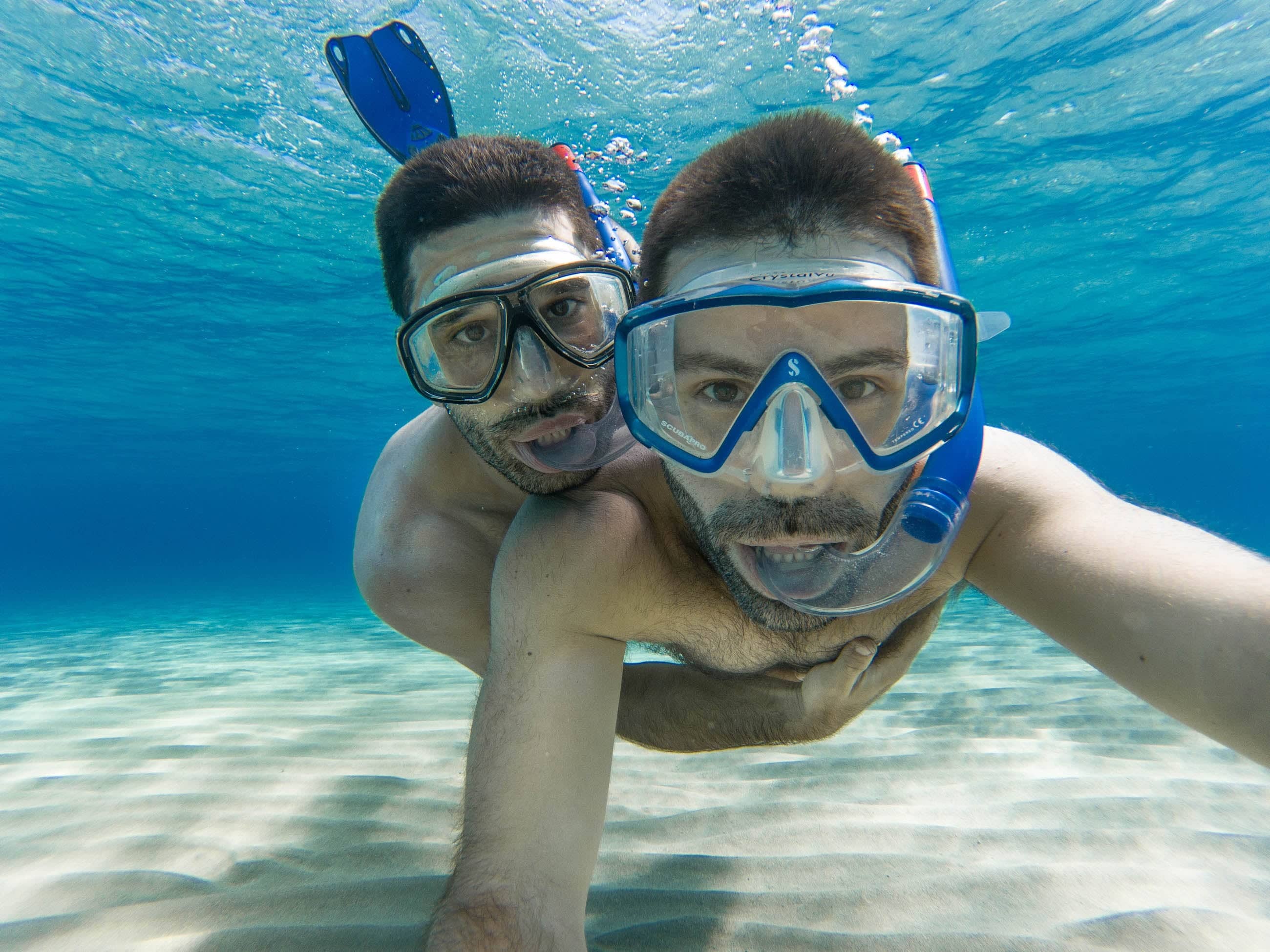 Gay couple snorkelling