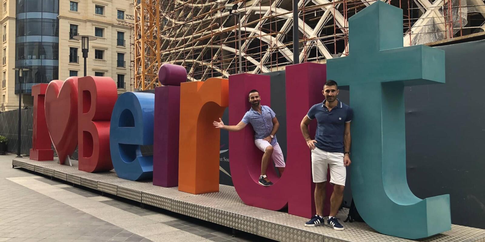 Gay couple at the I Love Beirut sign in the Beirut Souks neighbourhood