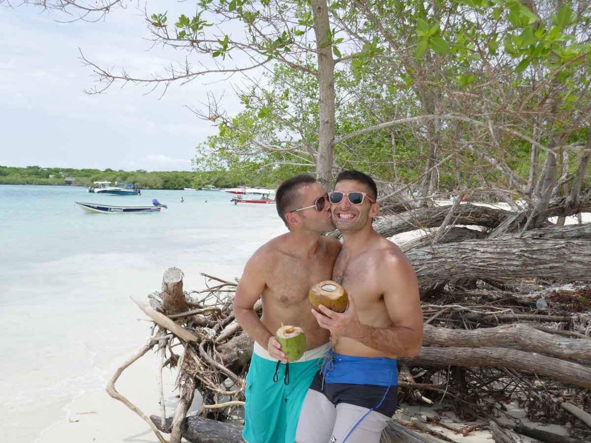 Gay couple embracing at the Playa Blanca beach in Cartagena