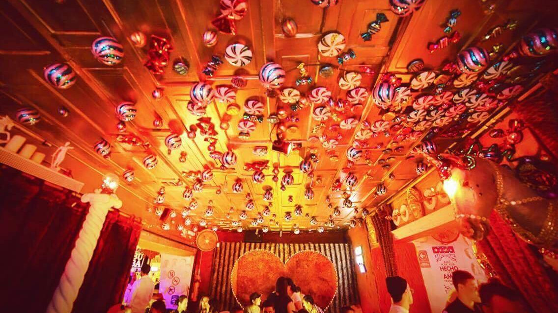 The brightly lit up roof of Bar Chiquita, with lollies under red and yellow lights.