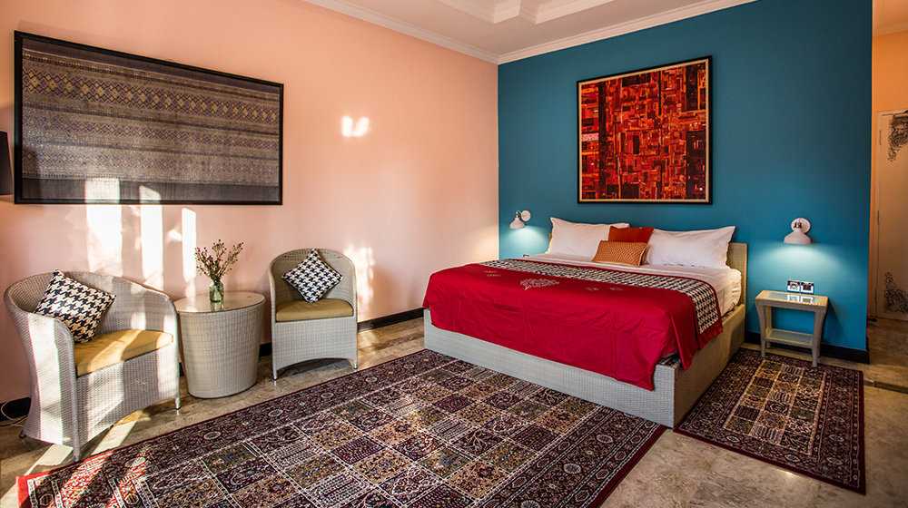 A colorful bedroom with cosy rugs at the Laki Uma Villa in Bali.