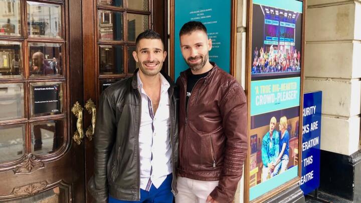 Gay couple Stef and Seby outside gay theatre in London