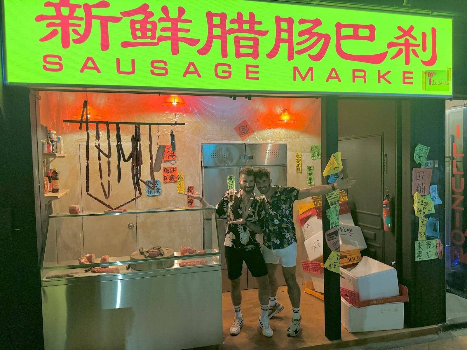 Gay couple in front of the Sausage Market gay bar in Singapore.
