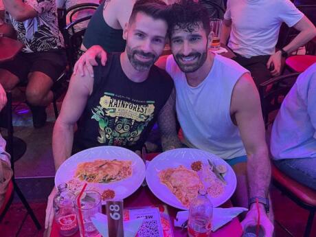 Stefan and Sebastien posing with yummy plates of pad Thai at Pride/Circus bar in Bangkok.