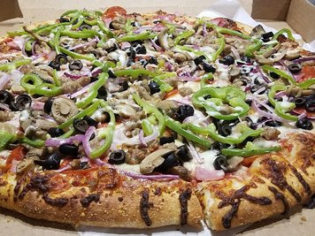 A close up shot of a New York style pizza loaded with toppings!