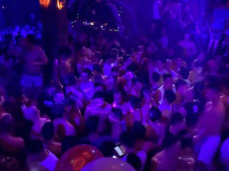A blurry dancing crowd at ZAG gay club in Phuket's Patong Paradise Complex.