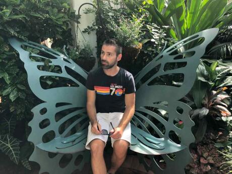 Seby thinking about Butterfiesy at the Butterfly conservatory in Key West