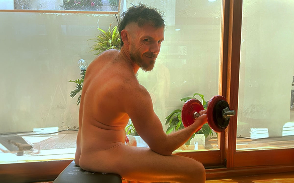 Man doing biceps curls at the Everything To Sea Naked Canary Island Experience