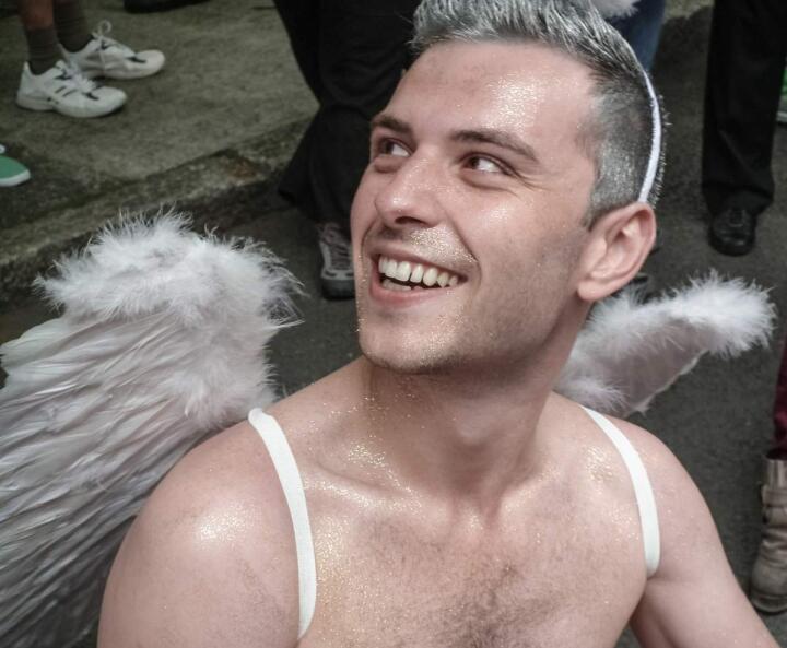 Cute gay guy in an angel outfit for Halloween gay party