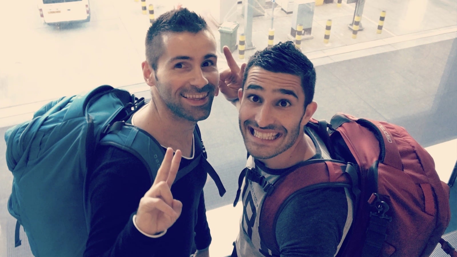 Gay couple traveling with backpacks