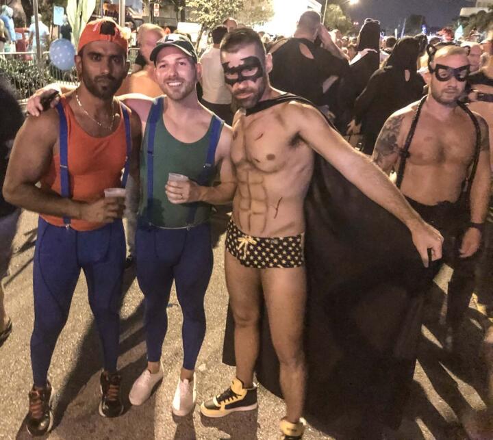 Gay couple dressed as Mario and Luigi for Halloween gay party