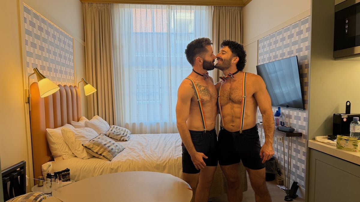 Gay couple kissing at the Citadines Canal gay hotel in Amsterdam.