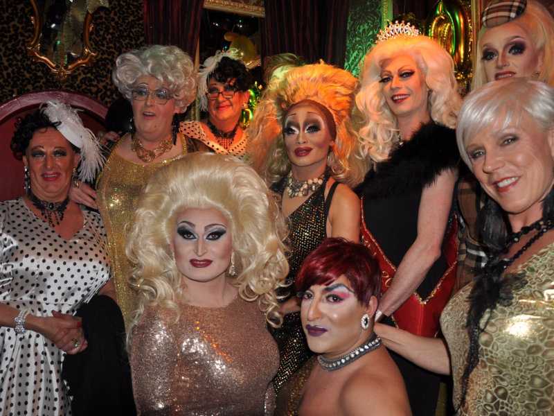 A group of fierce drag queens posing together at Dragshowbar Lellebel in Amsterdam.