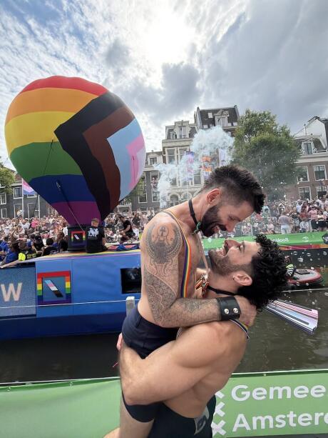 Stefan holding up Seby at the Amsterdam WorldPride in 2026.