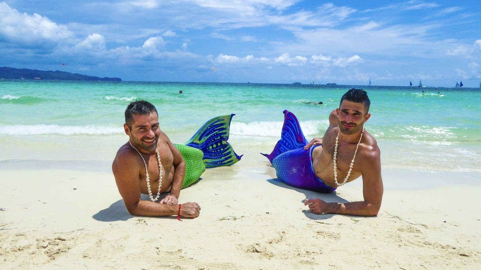 Gay couple dressed as mermaids on White Beach in Boracay, Philippines.