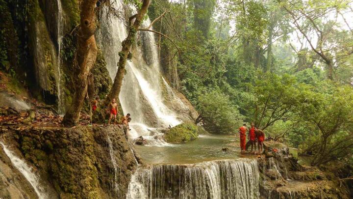 the Kuang Si Falls in Laos is a gorgeous tiered waterfall you need to visit while in the country