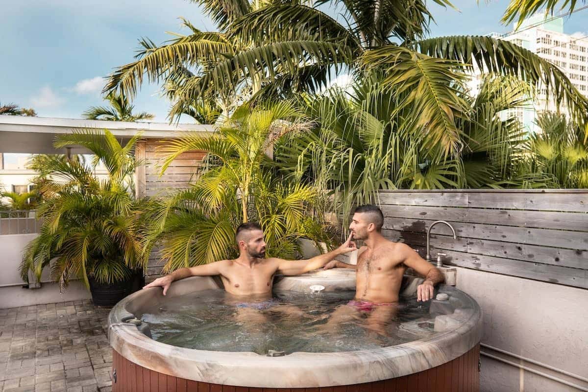 Gay couple in a hot tub in a gay hotel in Fort Lauderdale, Florida.