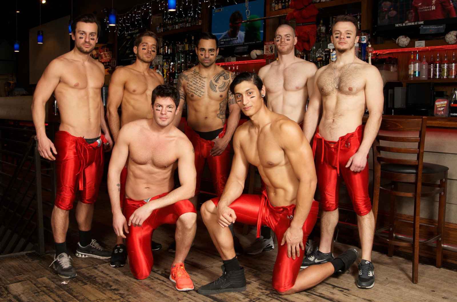 A group of sexy bartenders in boxing gear posing at the Boxers gay bar in New York City,