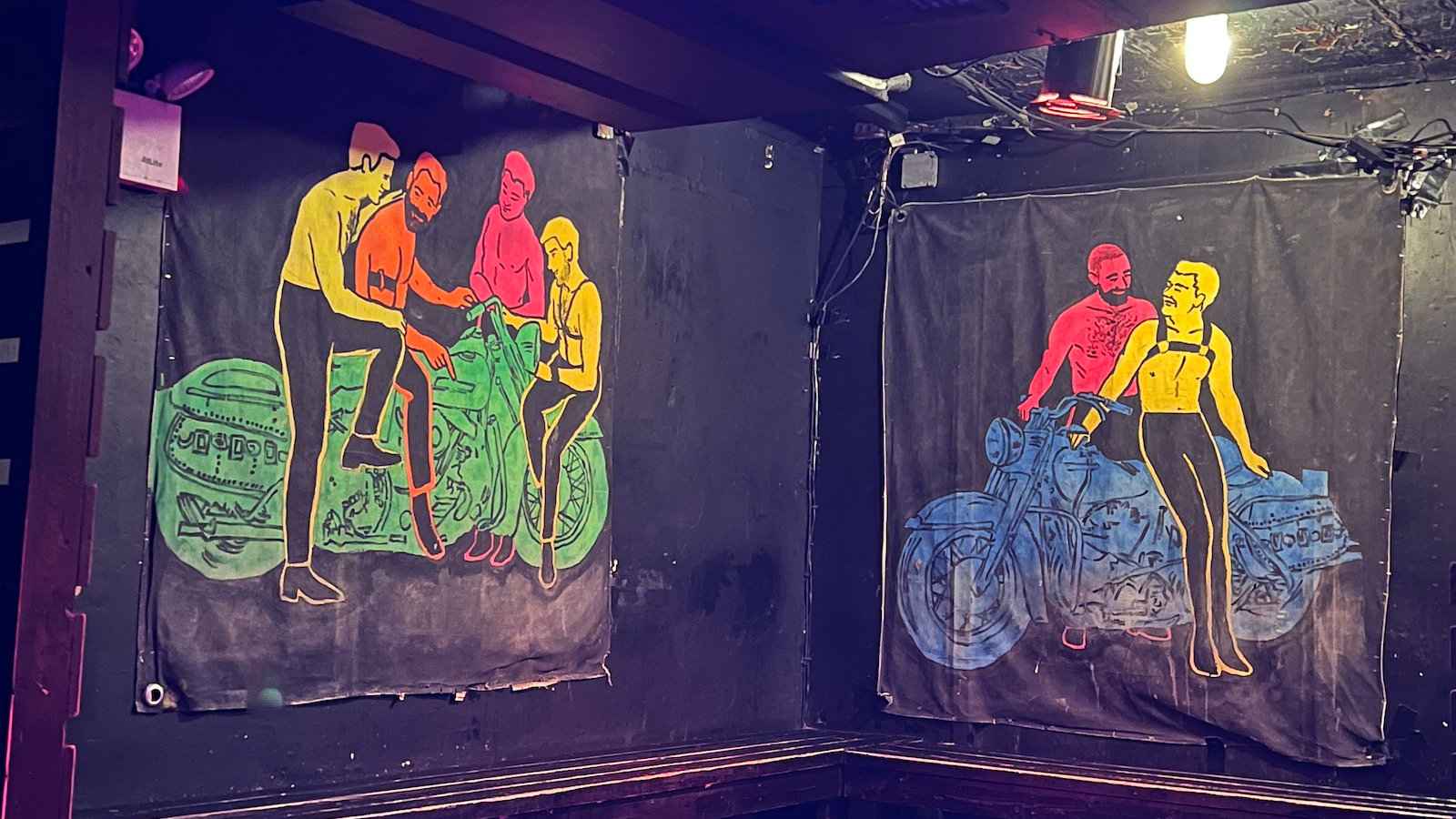 Colorful wall art showing gay men on motorbikes at the Eagle gay bar in New York City.