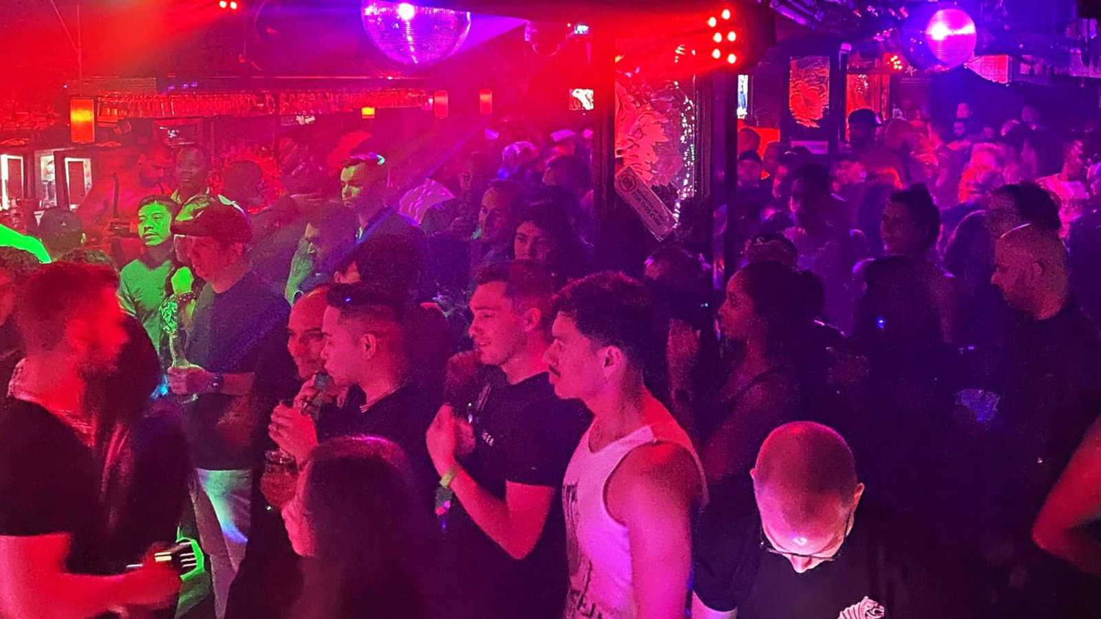 Gay men having fun on a packed dance floor at the Monster gay bar in New York City.