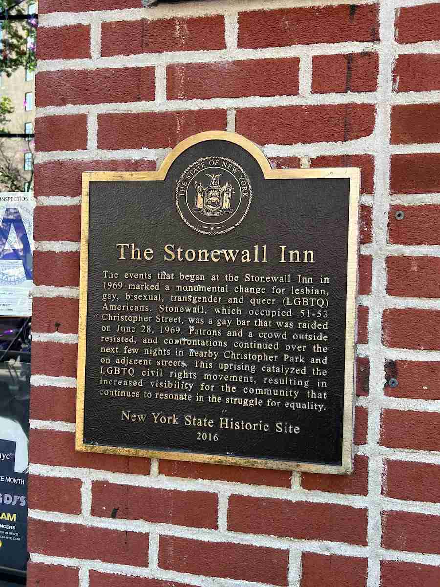 A plaque on bricks with information about the Stonewall Inn in New York City.