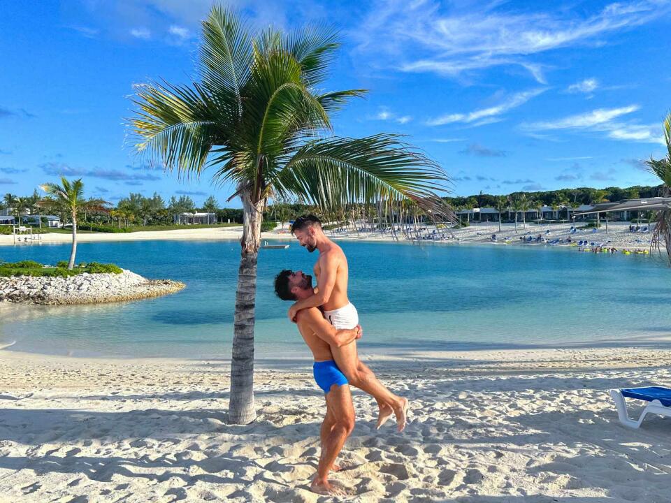 Gay couple hugging in Great Stirrup Cay in the Bahamas