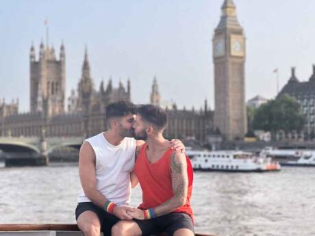 Gay couple kissing in London in front of Big Ben. Photo by Nomadic Boys. 