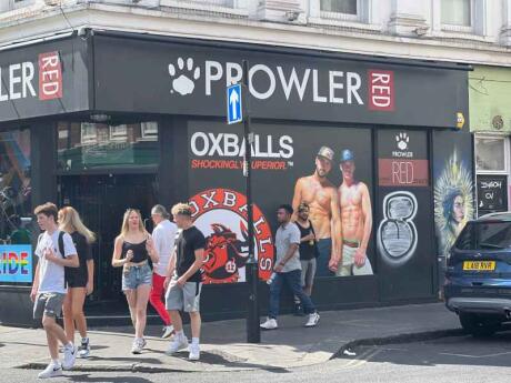 People walking in front of Prowler is, a gay shop in London.