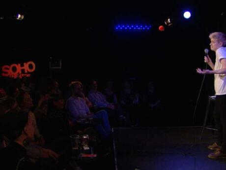 Stand up comedian speaking tot he crowd at The Soho Theatre, one of the biggest gay theaters in London.