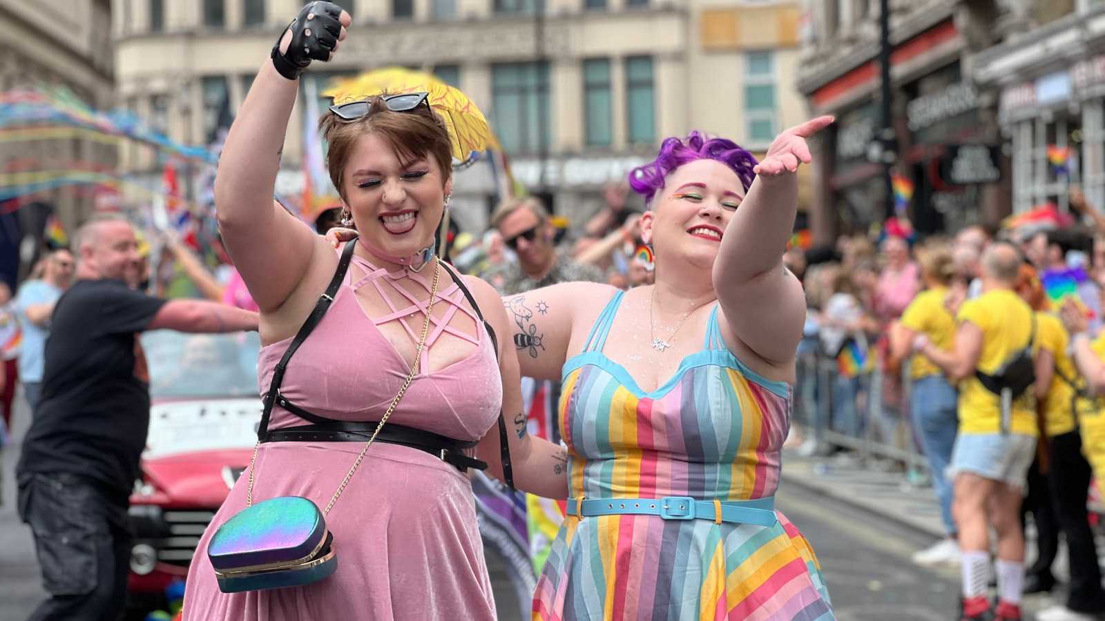 Cute lesbian couple marching at London Pride.