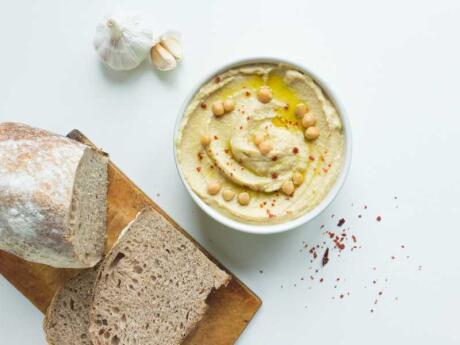 Fattet hummus is mixed with pieces of pita bread, tahini and pine nuts.