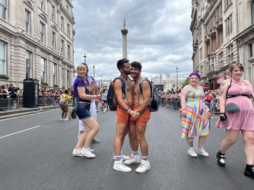 Gay couple kissing at Trafalgar Square during the London Pride Parade.