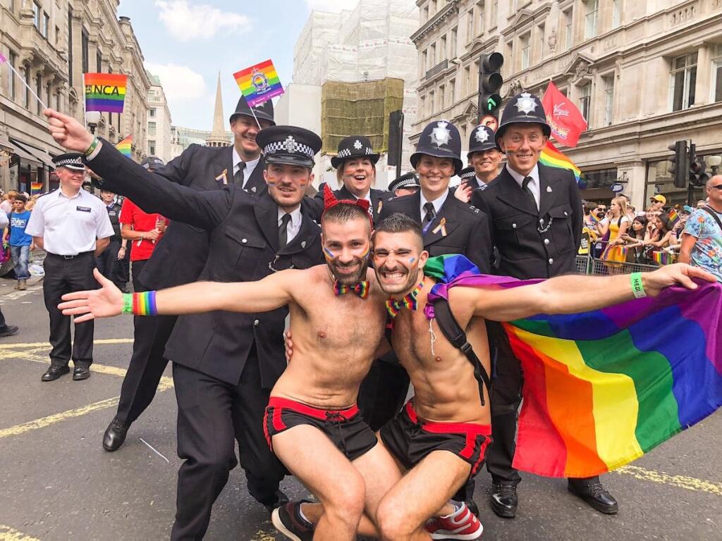 Gay couple with the LGBTQ Metropolitan Police group at the London Pride Parade.