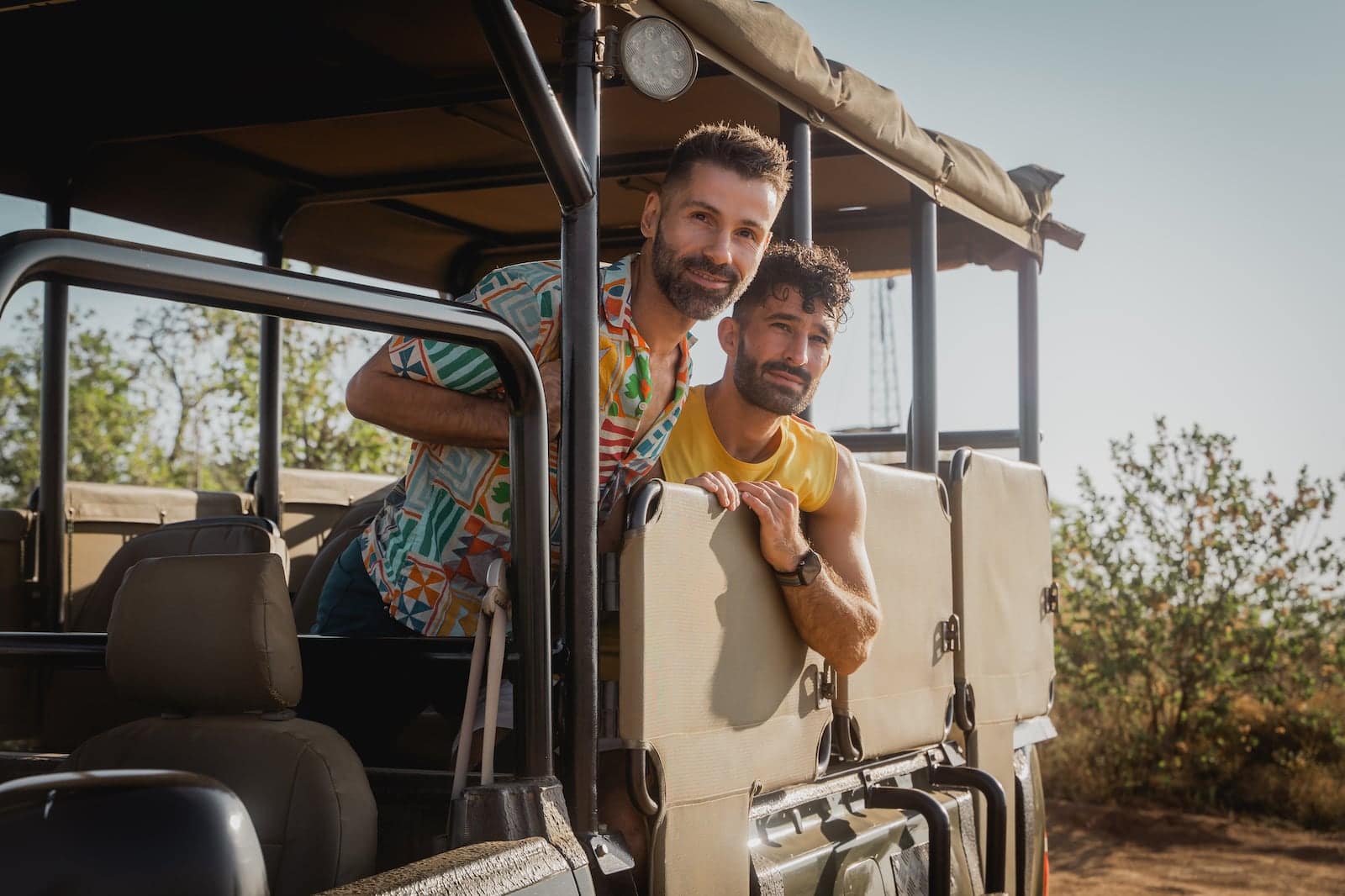 Gay couple in a safari jeep in South Africa.