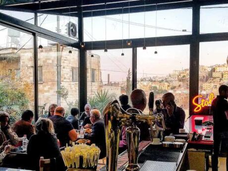 The inside of gay friendly Books cafe bar overlooking the city of Amman.